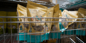 Lark Ellen Farm's granola bags on a grocery store shelf