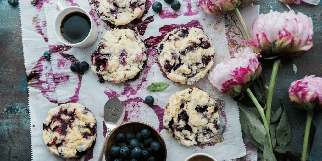 Blueberry scones, coffee and peonies on a table