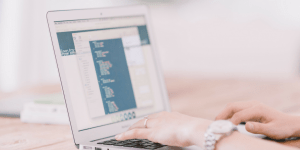 image of woman on laptop looking at reporting data