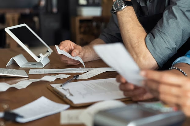image of two people going over receipts and registar system