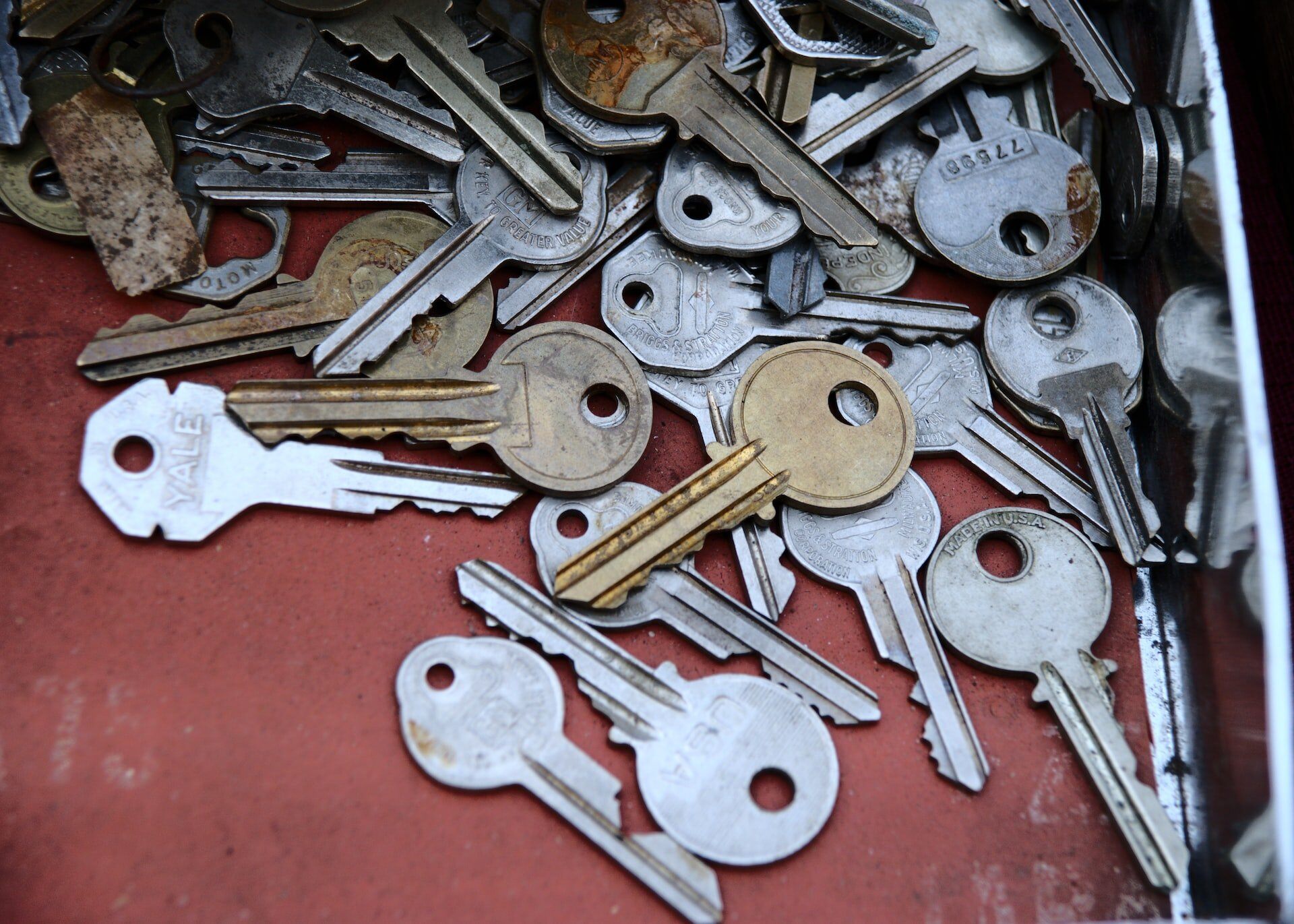 a close up of a large collection of keys, laid out on a red surface
