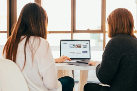 CFO advisor and founder reviewing growth dashboards on laptop – fractional CFO services