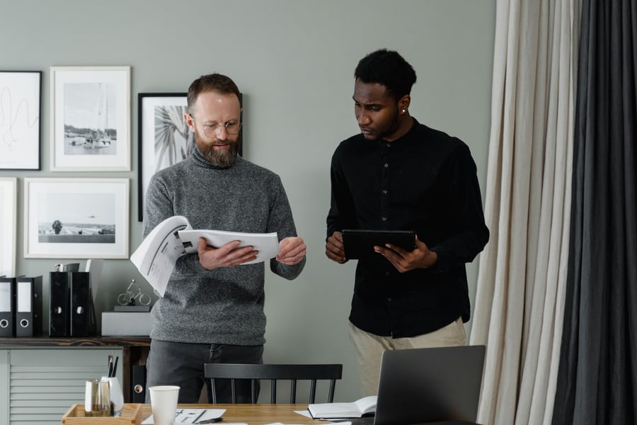 Consultants reviewing client files in a modern office — professional services firm