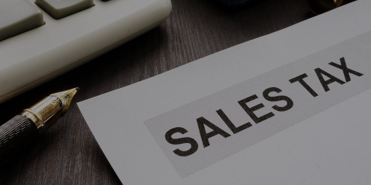 Sales tax document on desk with pen and calculator