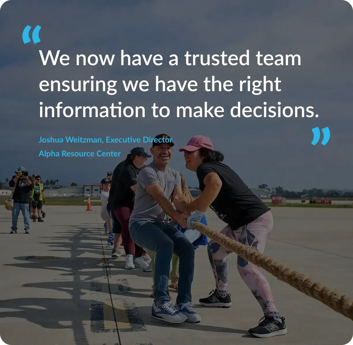 Alpha Resource Center team playing tug-of-war behind an Accountix nonprofit outsourced accounting testimonial.