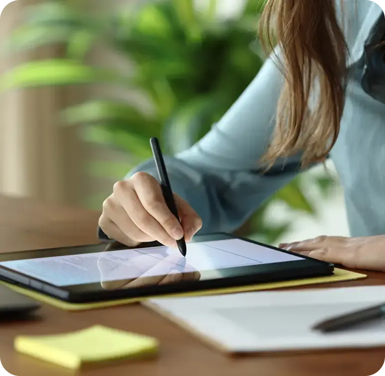 Professional reviewing cash flow modeling benefits and stress-testing financial scenarios on a tablet.