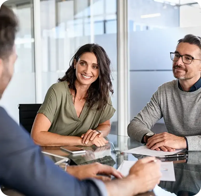 Business owners smiling during a meeting about margin insights and data-backed pricing strategies.