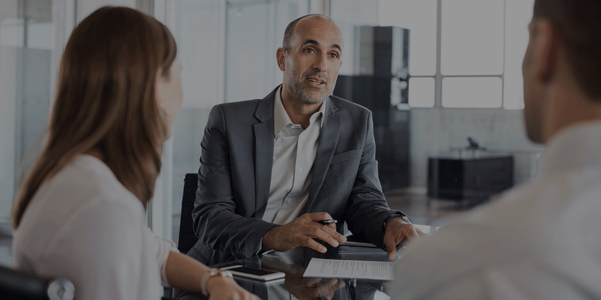 Executive discussing scope and pricing options with clients while assessing an outsourced accounting firm’s fit.