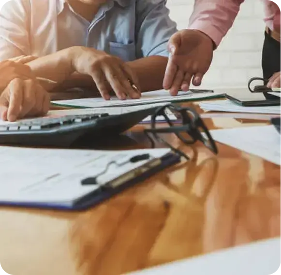 Professionals reviewing paperwork to compare outsourced accounting and CFO services.