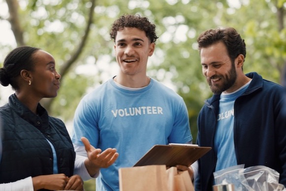 Volunteer explaining details to team members at a nonprofit donation drive.
