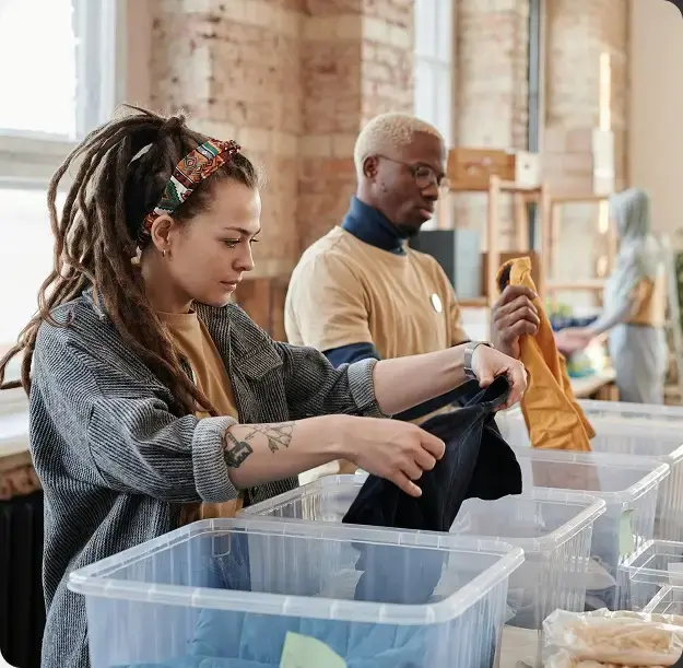 Volunteers sorting clothes for a charity, supported by the Accountix nonprofit accounting firm.