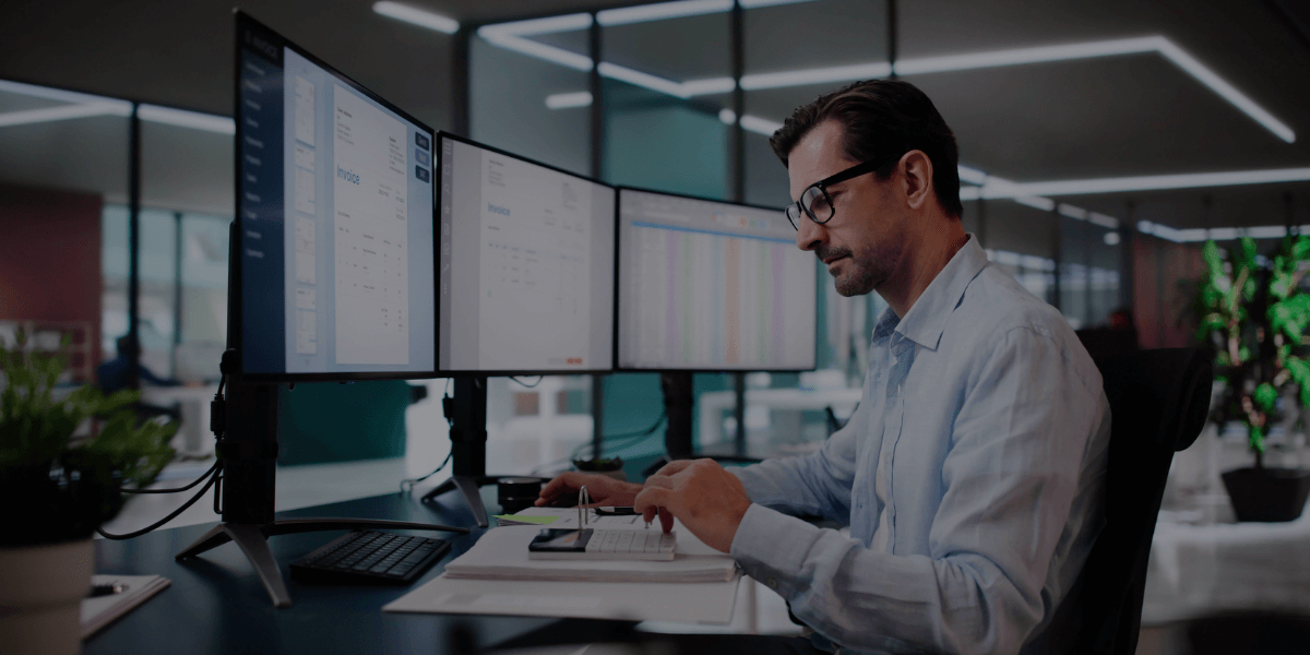 Business professional reviewing financial data while evaluating outsourced accounting vs in-house accounting options