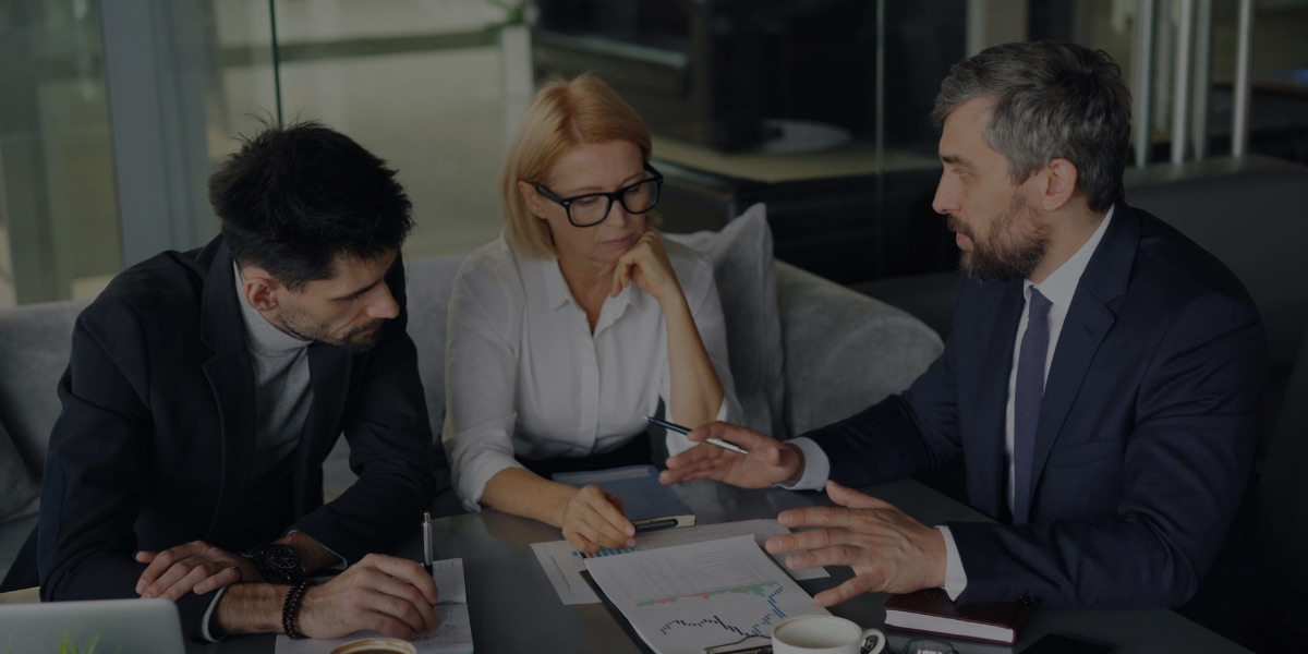 Professional services team reviewing accounting reports, profitability analysis, and financial metrics during client strategy meeting