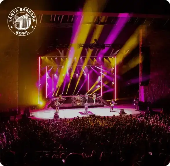Live concert at Santa Barbara Bowl with colorful stage lights and a large crowd