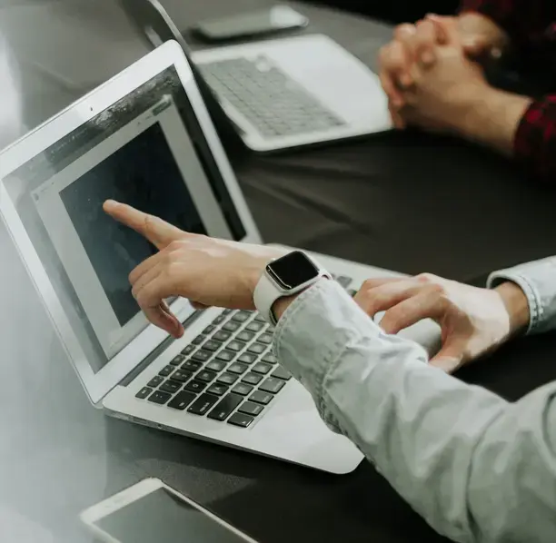 Professionals collaborating on a laptop, reflecting the full-service financial support we provide in Santa Barbara.