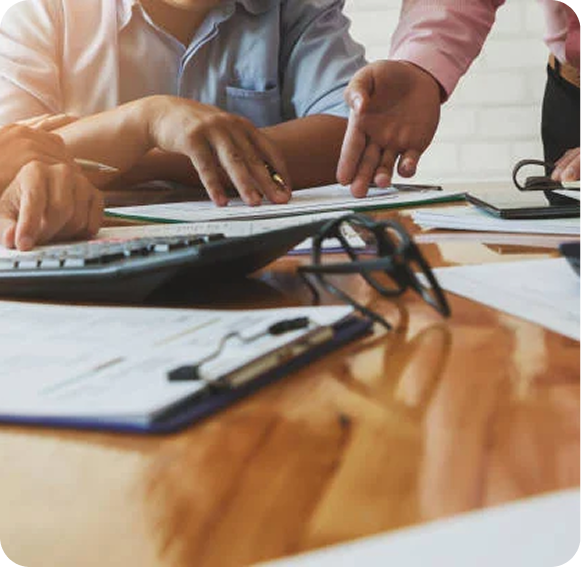 Professionals reviewing paperwork to compare outsourced accounting and CFO services.