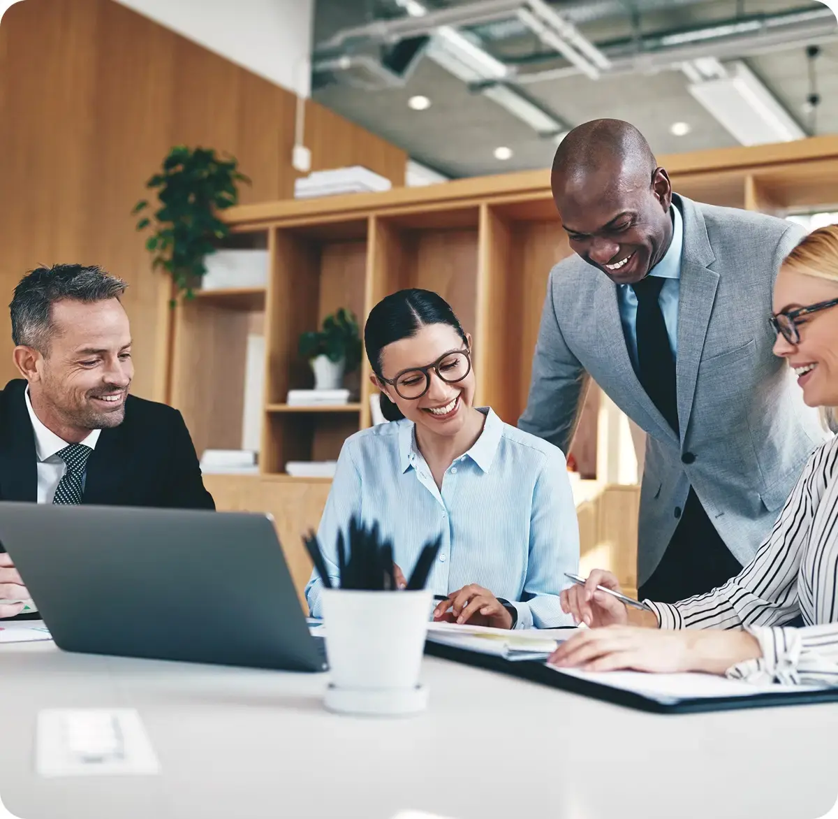 Accountix team of financial experts collaborating happily over a laptop and documents.
